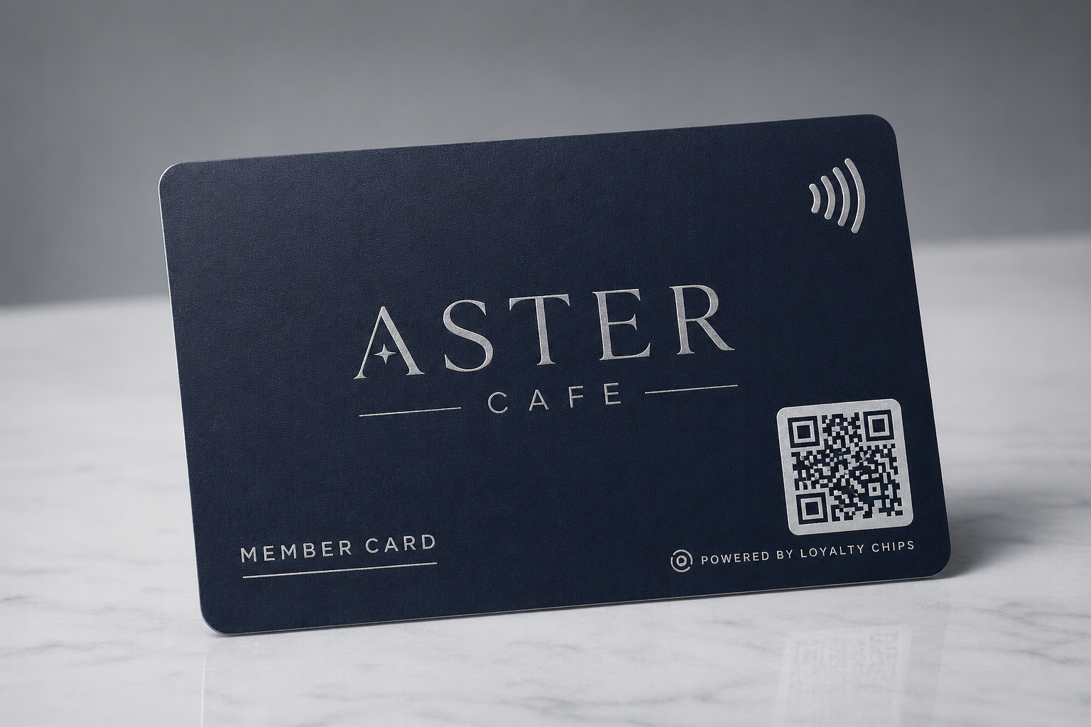 Aster Cafe navy plastic member card with an NFC-wave glyph and a printed QR block.