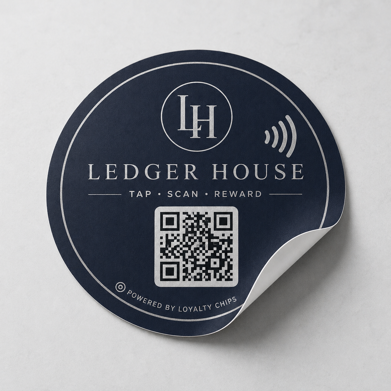 Ledger House navy NFC sticker with QR block and small powered-by Loyalty Chips mark.